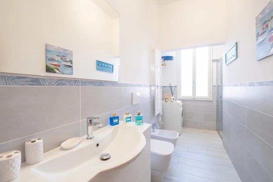 Bagno con lavatrice e doccia in un appartamento uso foresteria